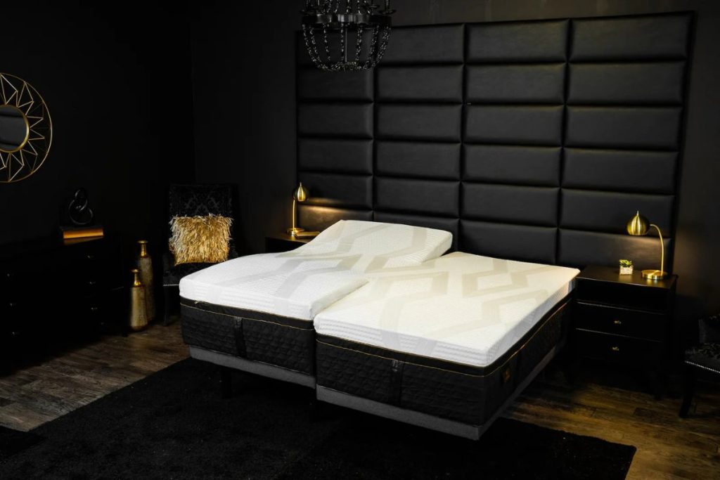 Adjustable split king mattress on a stylish black platform bed in a modern bedroom setting, highlighting the Juna H-Bed design for couples seeking seamless sleep.