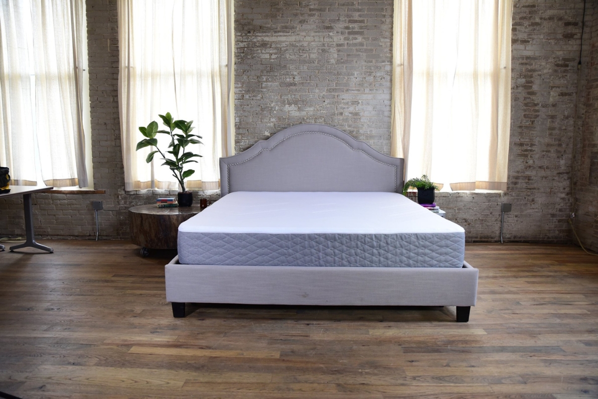 Premium luxury adjustable mattress with no-gap technology, set in a stylish room with natural light, emphasizing seamless comfort and handcrafted quality from Juna Sleep Systems.