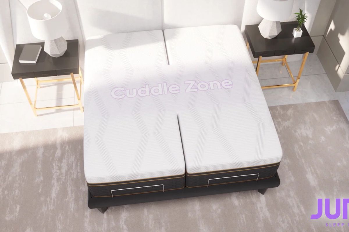 Intimacy-friendly adjustable mattress featuring "Cuddle Zone" design, promoting comfort for couples, with modern decor elements like bedside lamps and side tables.
