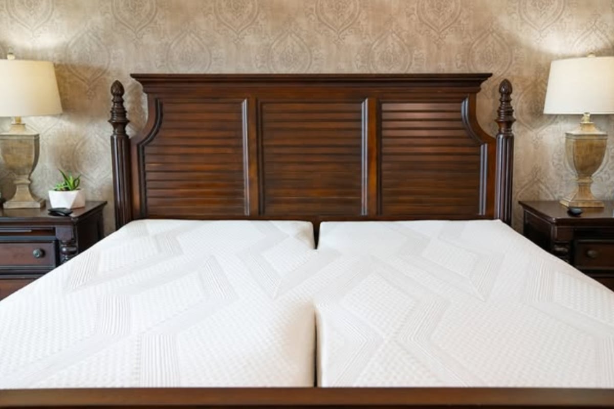 Split king mattress setup featuring two Twin XL mattresses side by side on a wooden bed frame, showcasing customization for couples' sleep preferences.