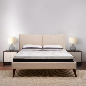 Juna H Bed with mattress on a stylish frame, accompanied by bedside tables and lamps, showcasing comfort and modern design for optimal sleep solutions.